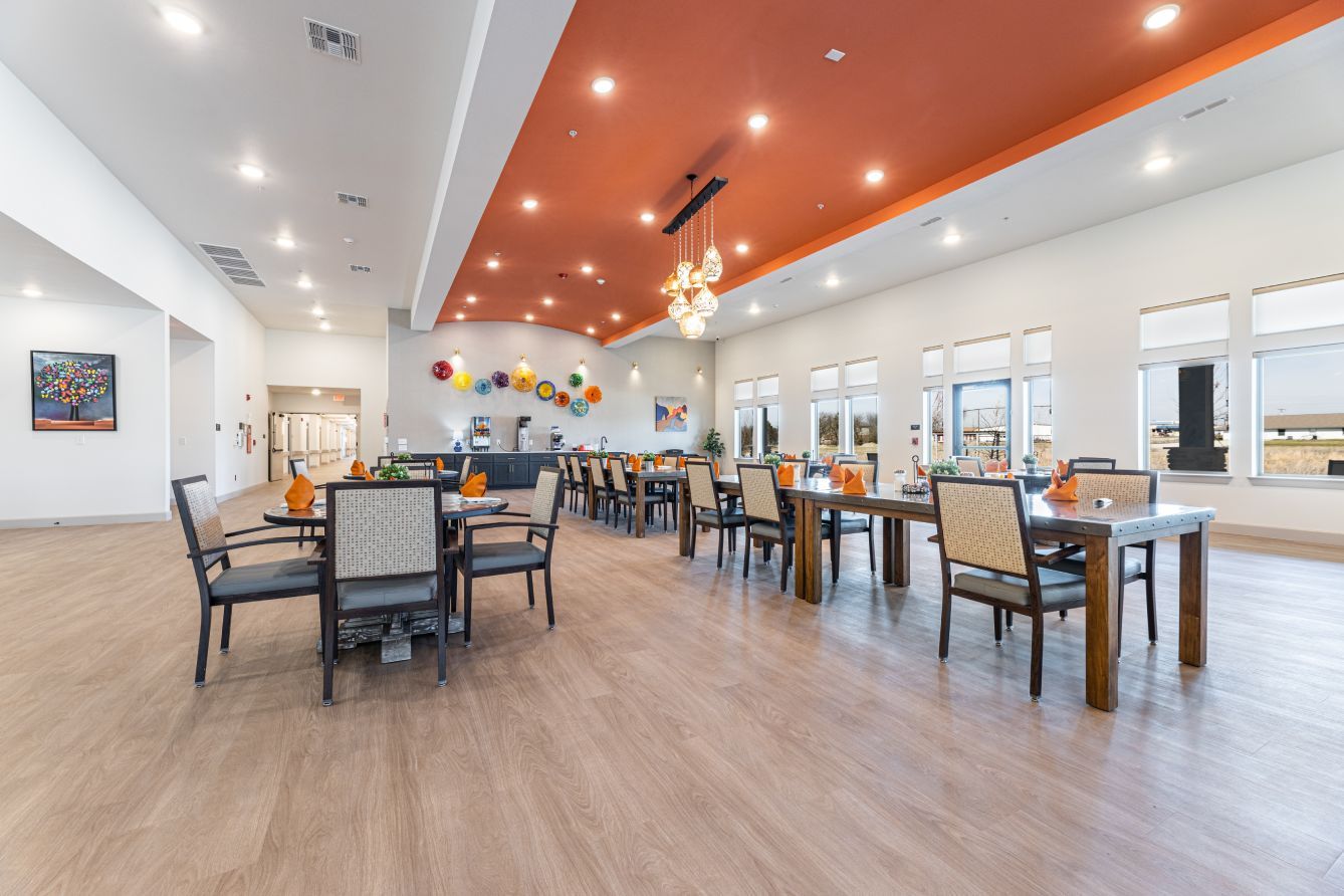Bright and spacious dining room with tables set for meals