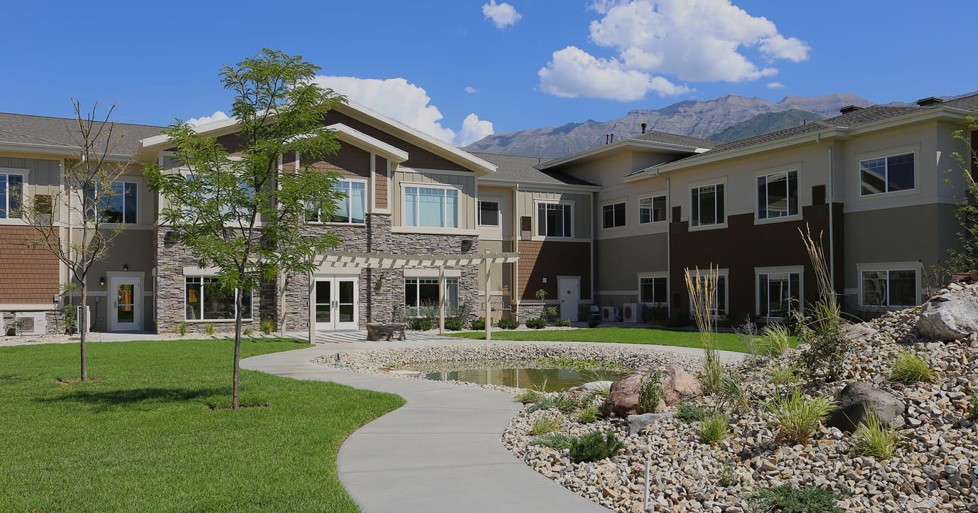 Exterior view of Covington Senior Living with landscaping