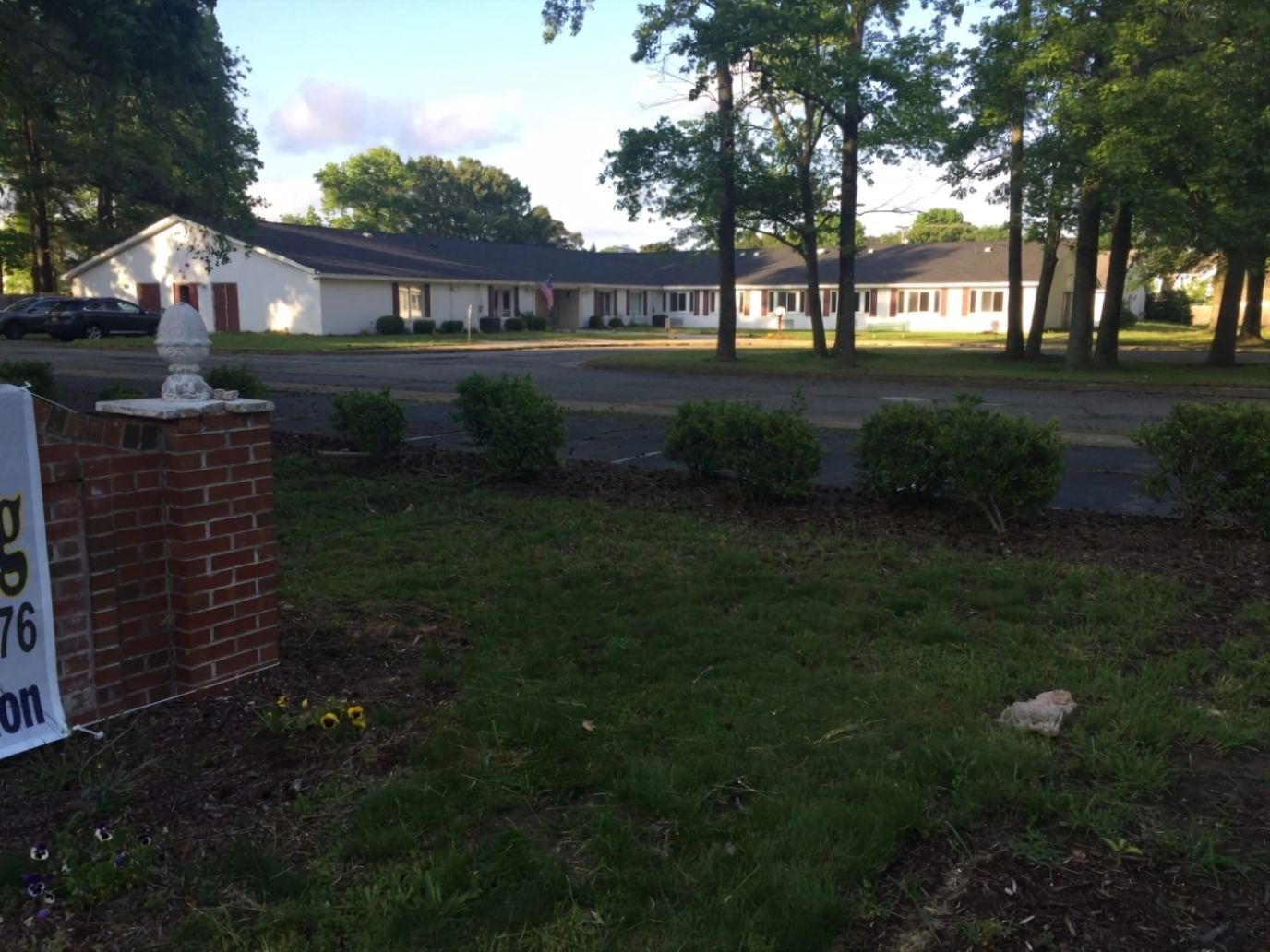 Exterior view of the assisted living facility surrounded by greenery