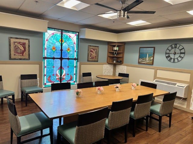 Dining area with a large table and stained glass window