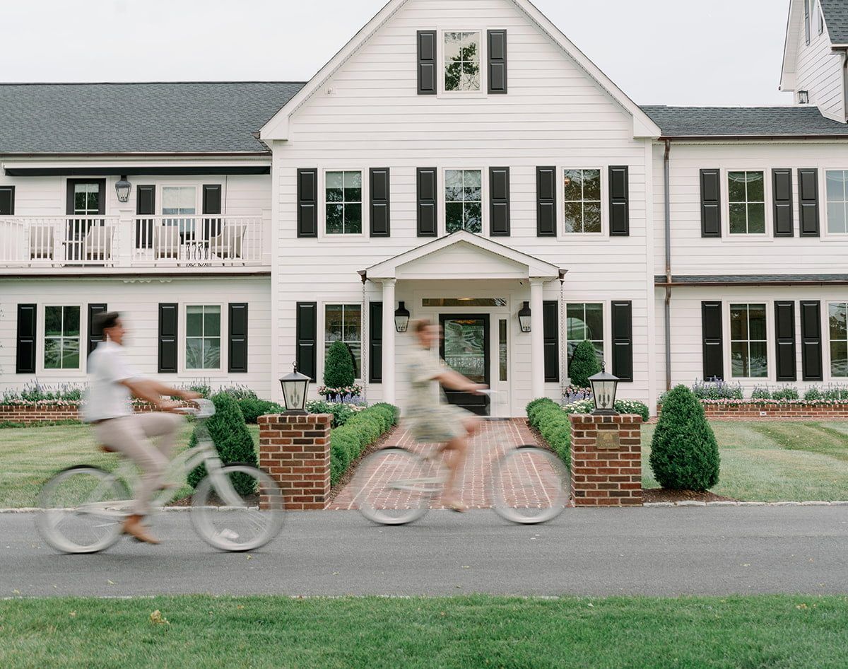 Residents biking in front of the facility exterior
