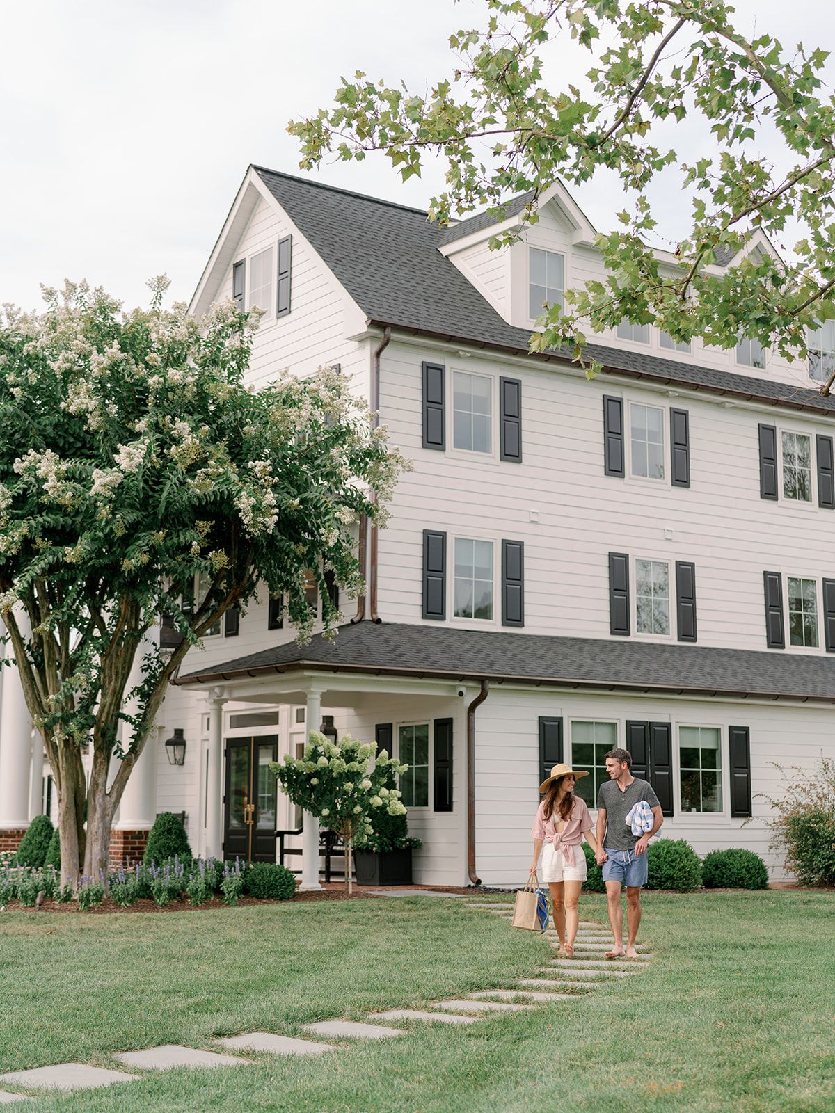 Couple walking in front of a residential facility.