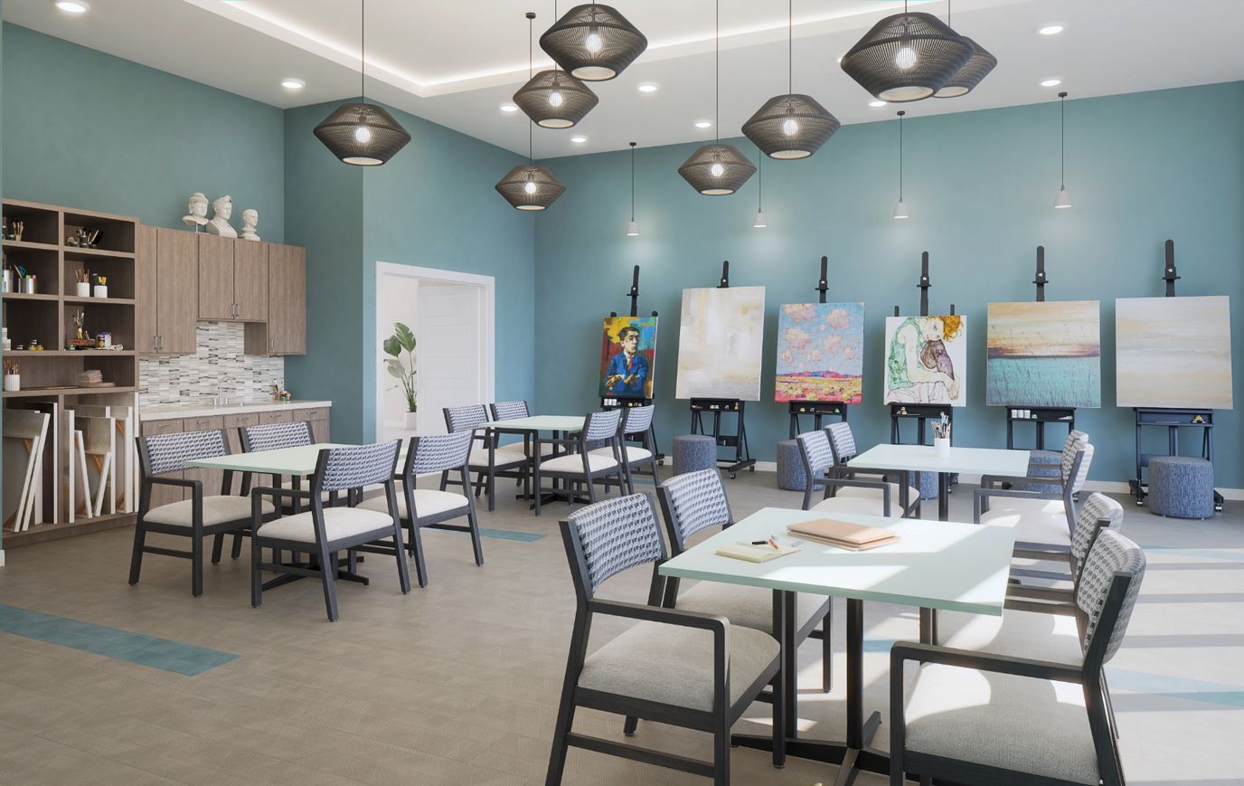 Bright, modern common area with tables and artwork