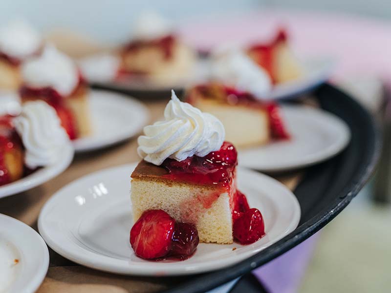 Dessert cake with cherries and whipped cream