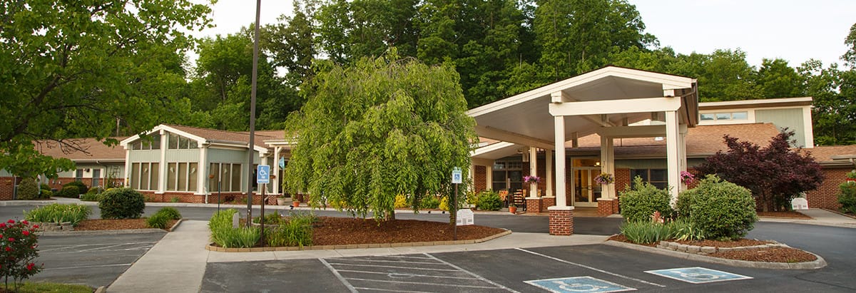 Exterior view of Preston Place Suites with landscaped entrance