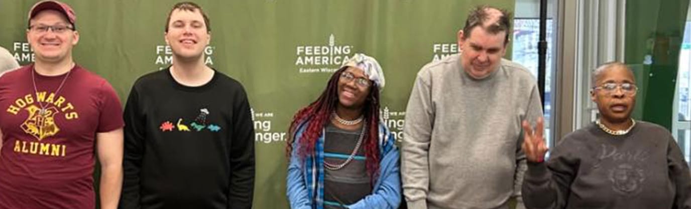 Five individuals at a community event