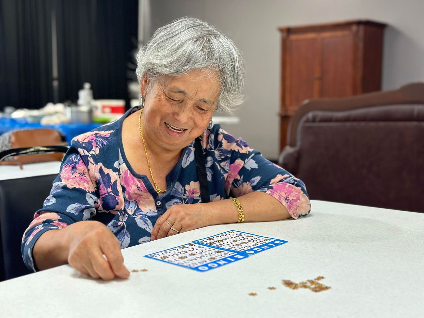 Resident playing bingo in an activity room