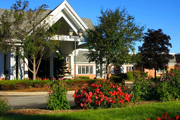 Building exterior with gardens and colorful flowers