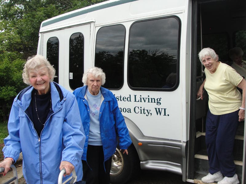 Residents exiting a facility transport van