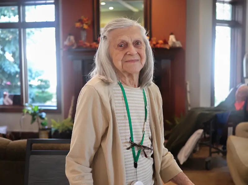 Elderly woman smiling in a common area