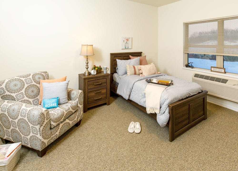 Cozy resident room with a bed and seating area