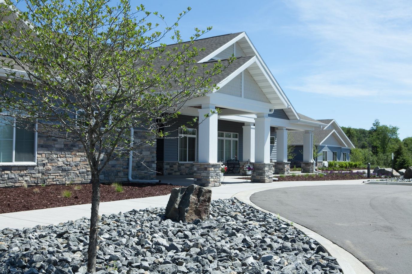 Exterior view of the senior living facility with landscaping