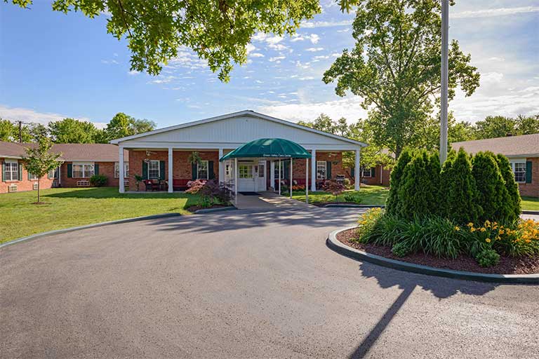 Exterior view of Green Valley Care Center with landscaped entry.
