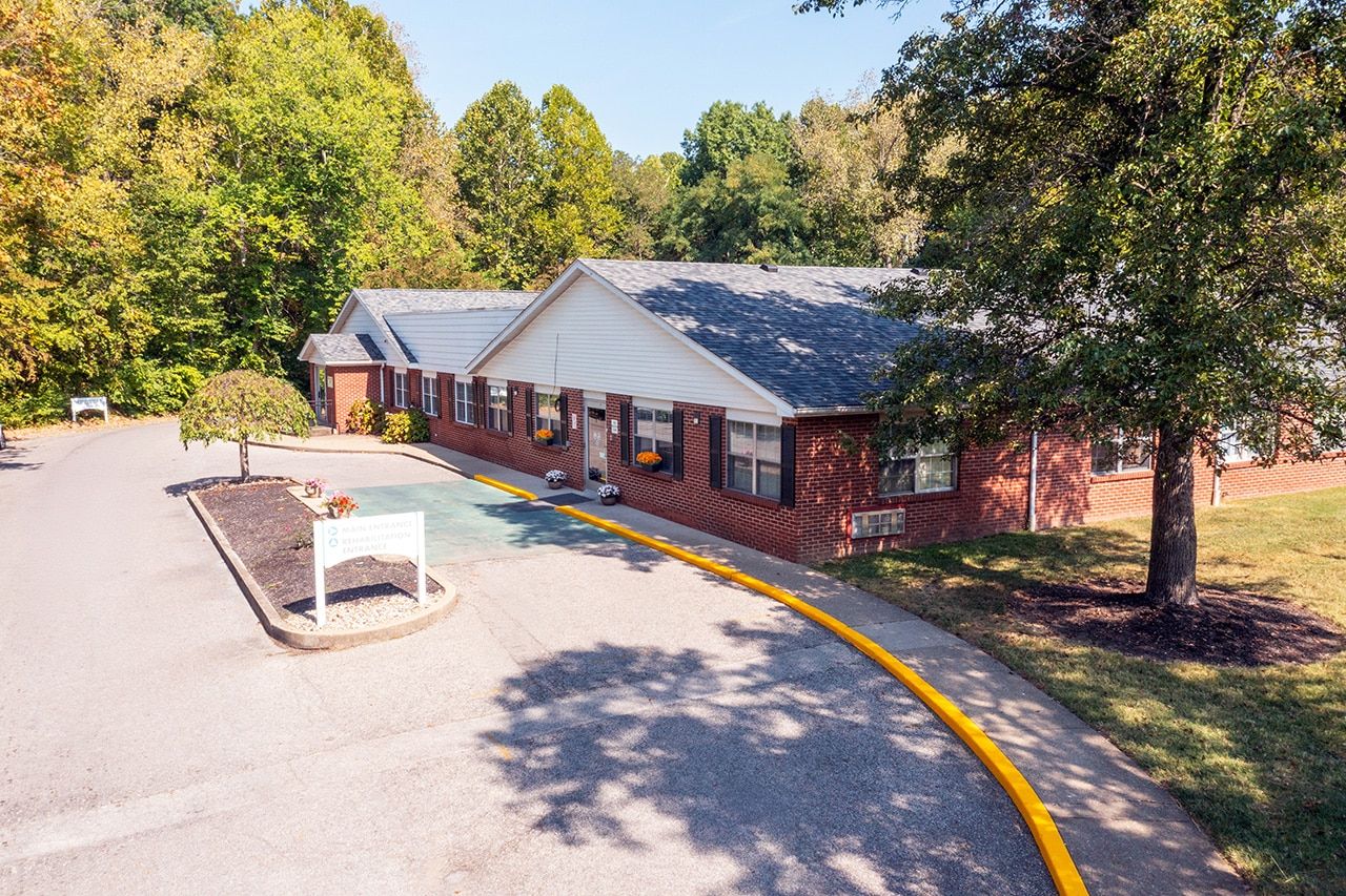 Exterior view of Wedgewood Healthcare Center surrounded by trees