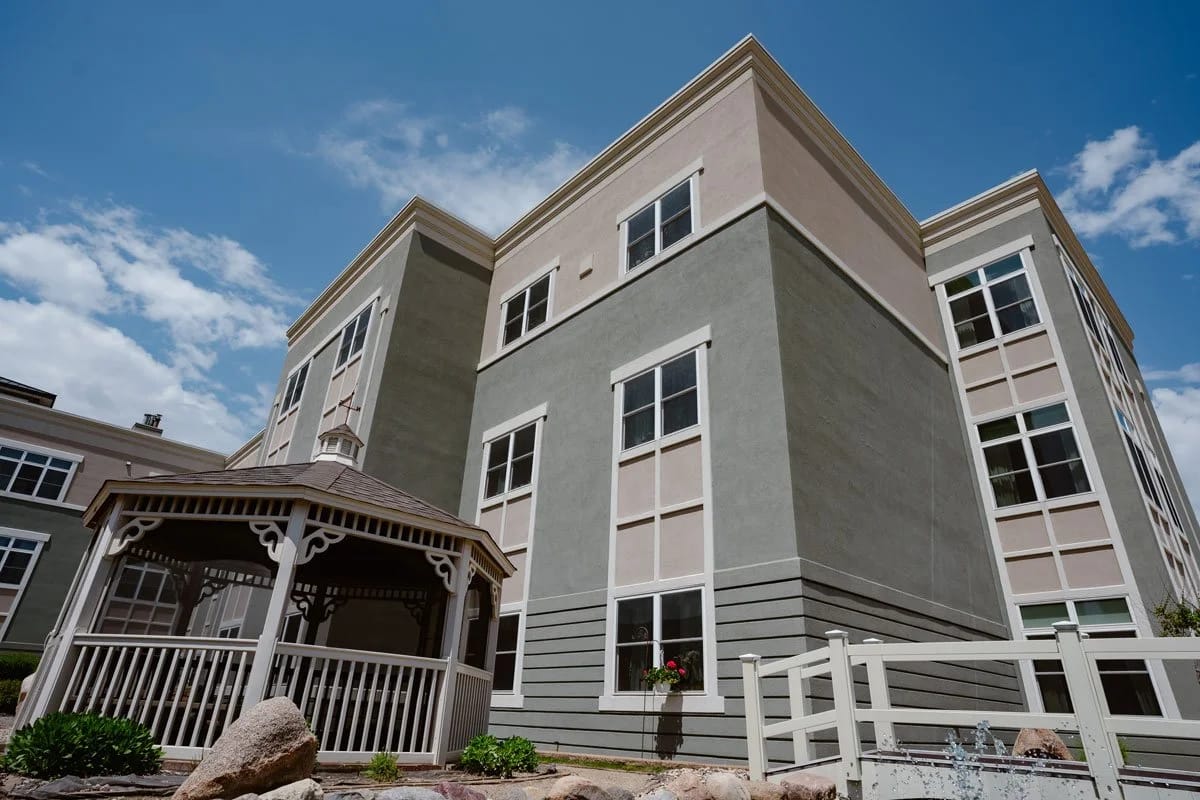 Exterior view of a senior living building with gazebo