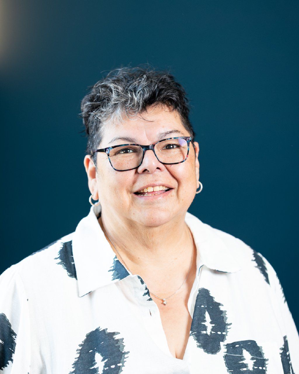 Close-up portrait of a smiling woman with glasses