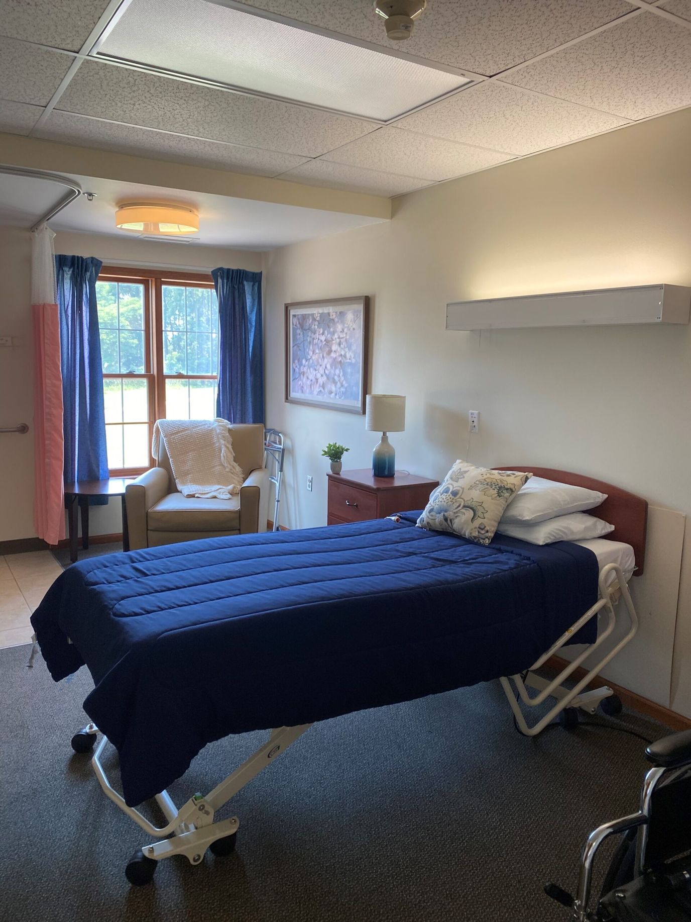 Private resident room with a bed and chair