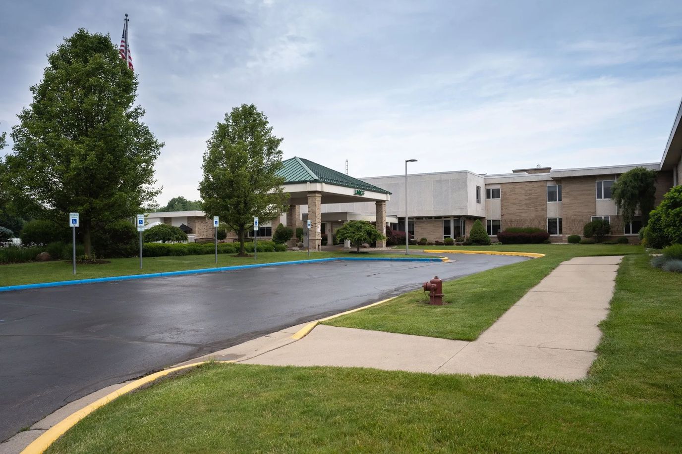 Entrance of Lenawee Medical Care Facility surrounded by landscaping
