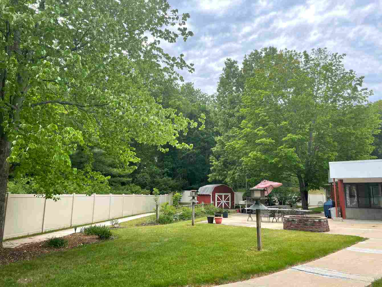 Outdoor garden area with trees and tables