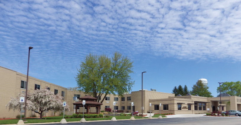 Exterior view of a senior living facility with landscaped garden