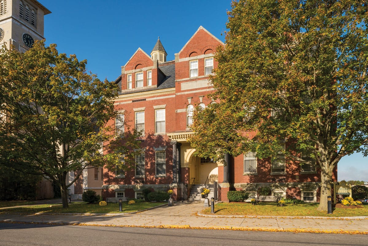 Exterior view of Corcoran House with trees and walkway