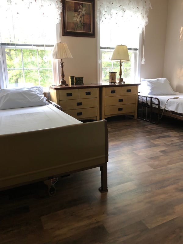 A cozy private resident room with two beds and nightstands