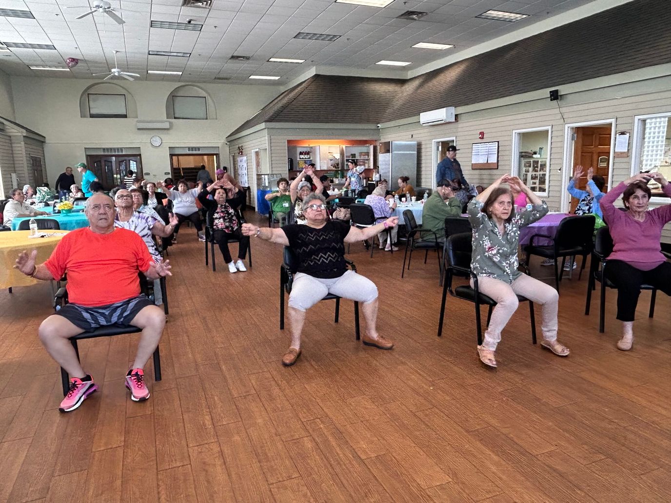 Residents participating in a seated exercise class.