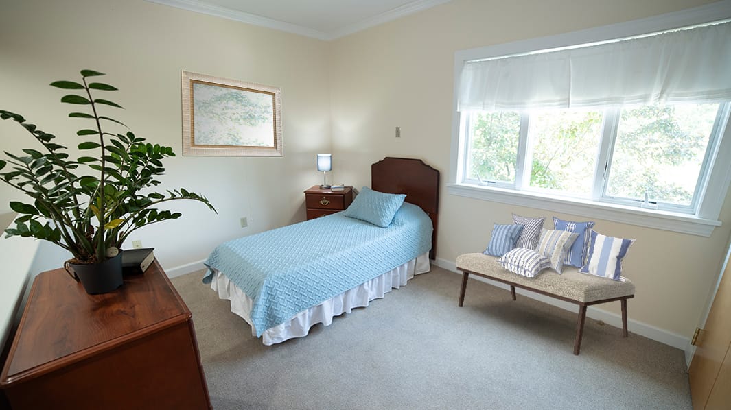 Cozy private resident room with bed and furnishings