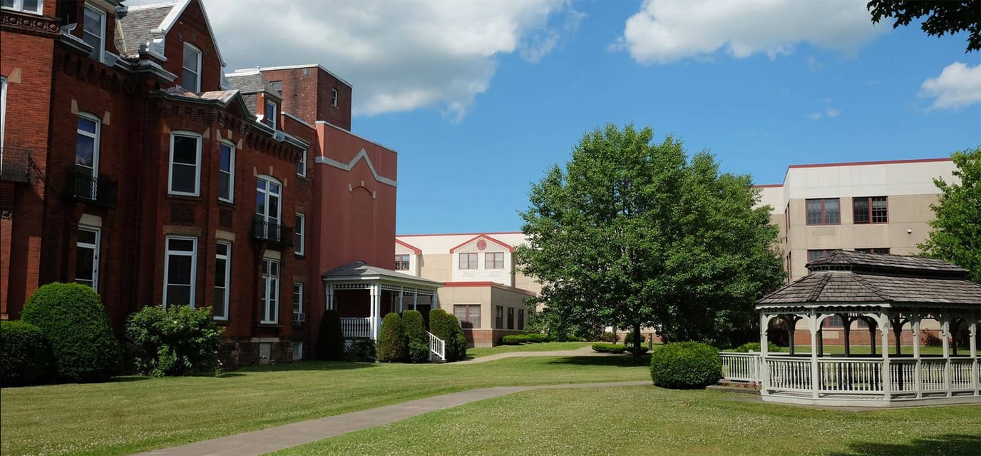Exterior view of a senior living facility with gardens