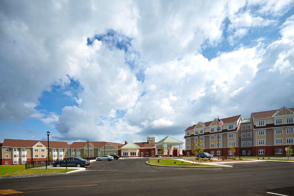 Exterior view of a senior living facility under a cloudy sky