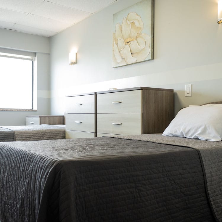 A well-furnished resident room with two beds