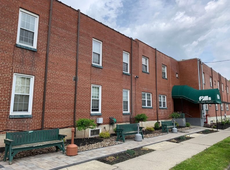 Exterior view of The New Falls facility with seating