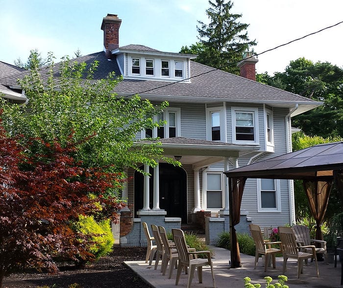 Exterior view of a senior living facility with outdoor seating