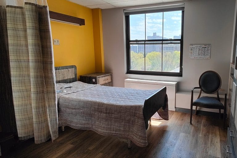 Private resident room with a bed and window