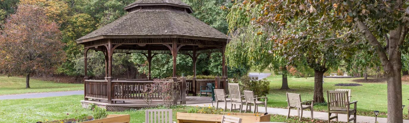 Gazebo surrounded by seating in a landscaped area