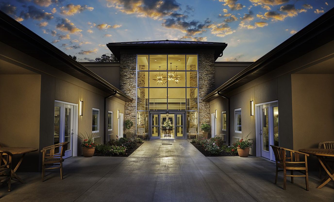 Exterior view of nursing home entrance at sunset