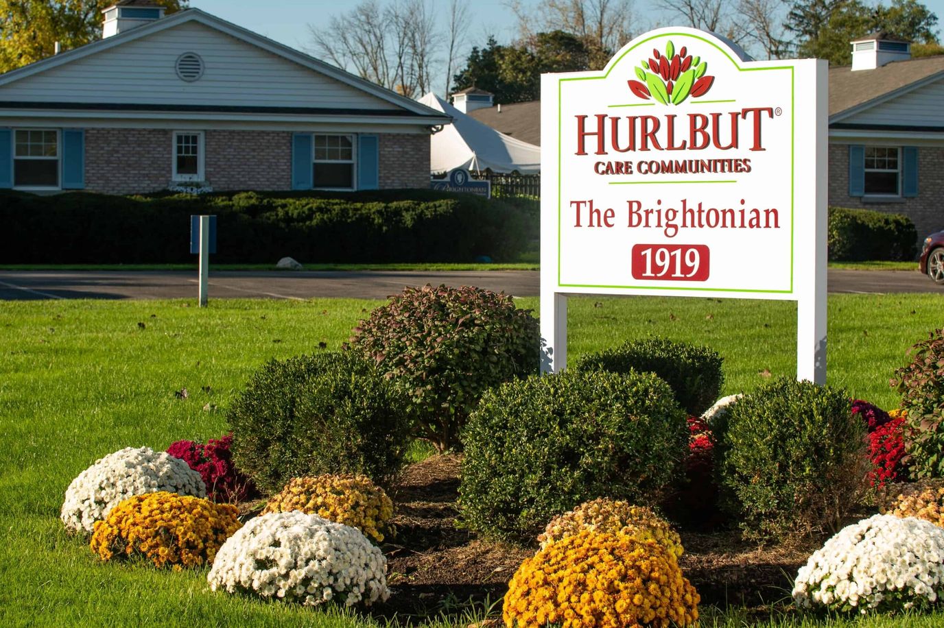 Sign displaying the name of The Brightonian with landscaped flowers