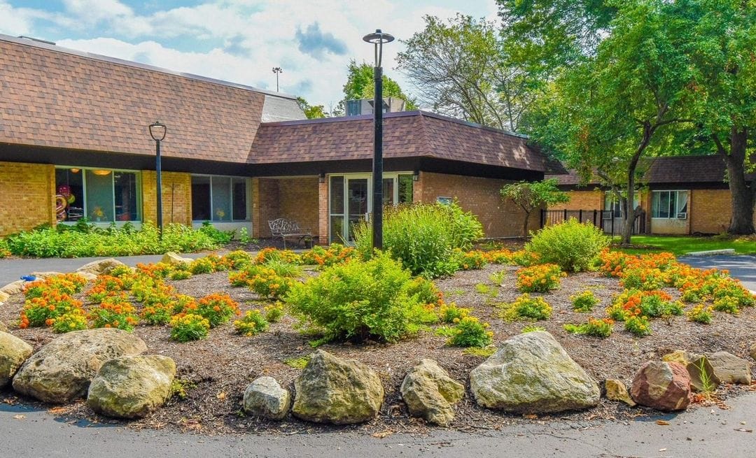Front exterior of Woodside Manor Nursing Home with garden
