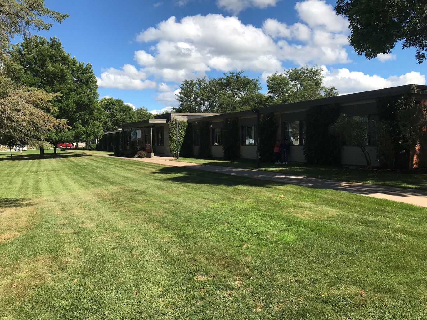 Exterior view of a nursing facility with green lawn