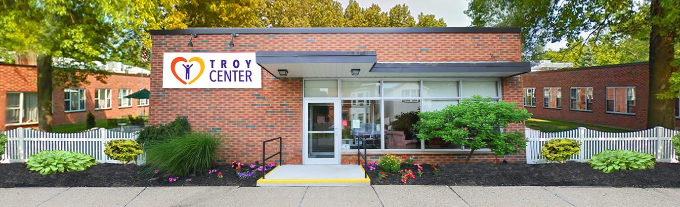 Exterior view of Troy Center with logo