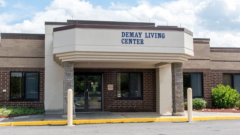 Exterior view of Demay Living Center with signage