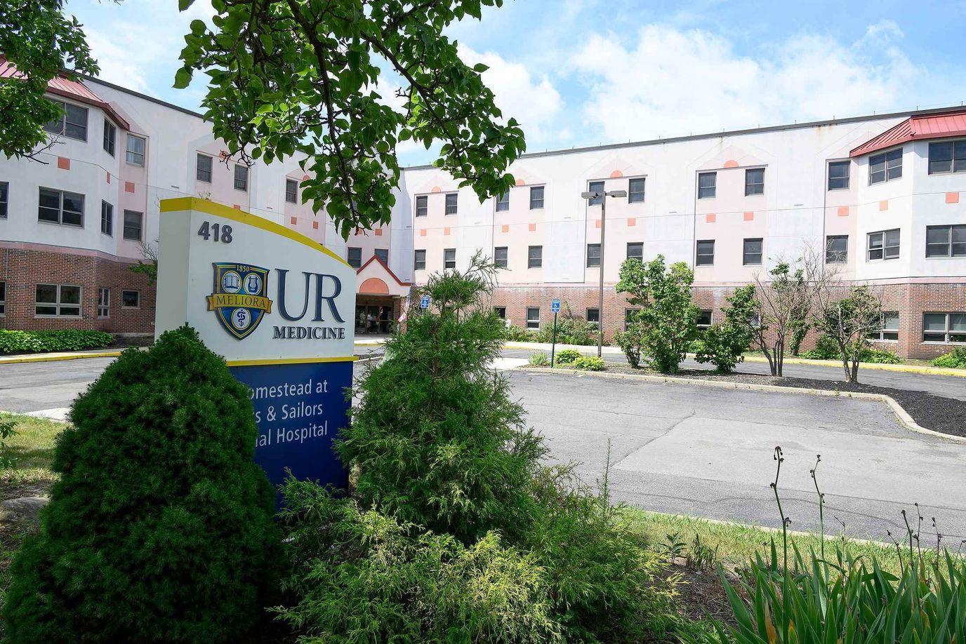 Facility exterior with the logo sign prominently displayed.