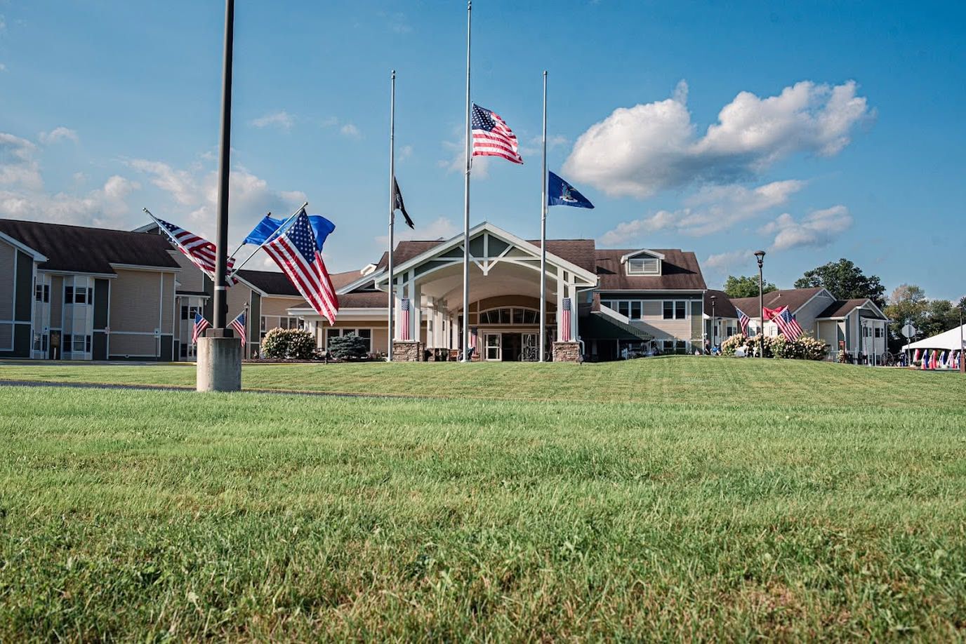 Front exterior of the New York State Veterans Home with flags