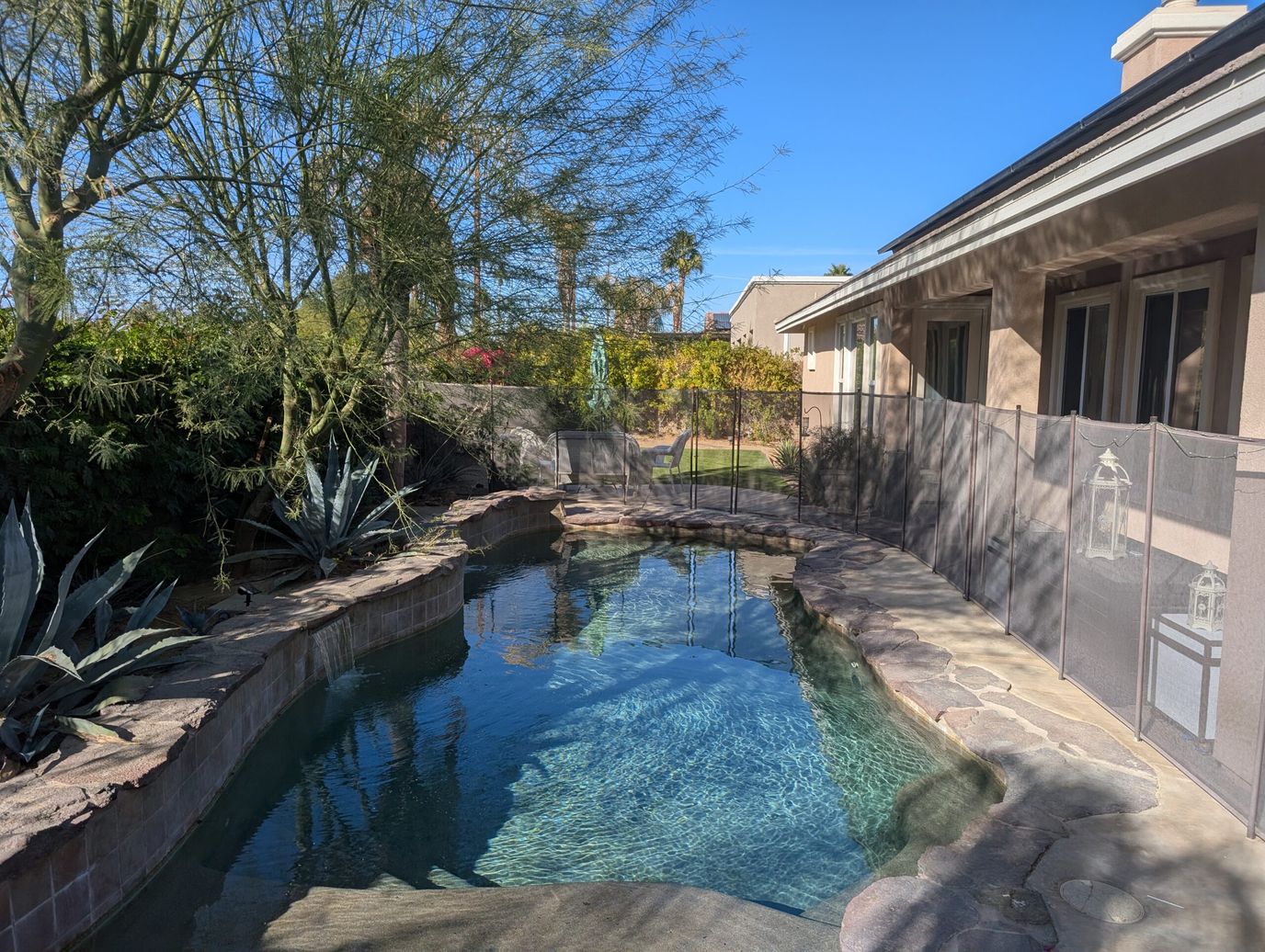 Tranquil outdoor pool area with landscaping