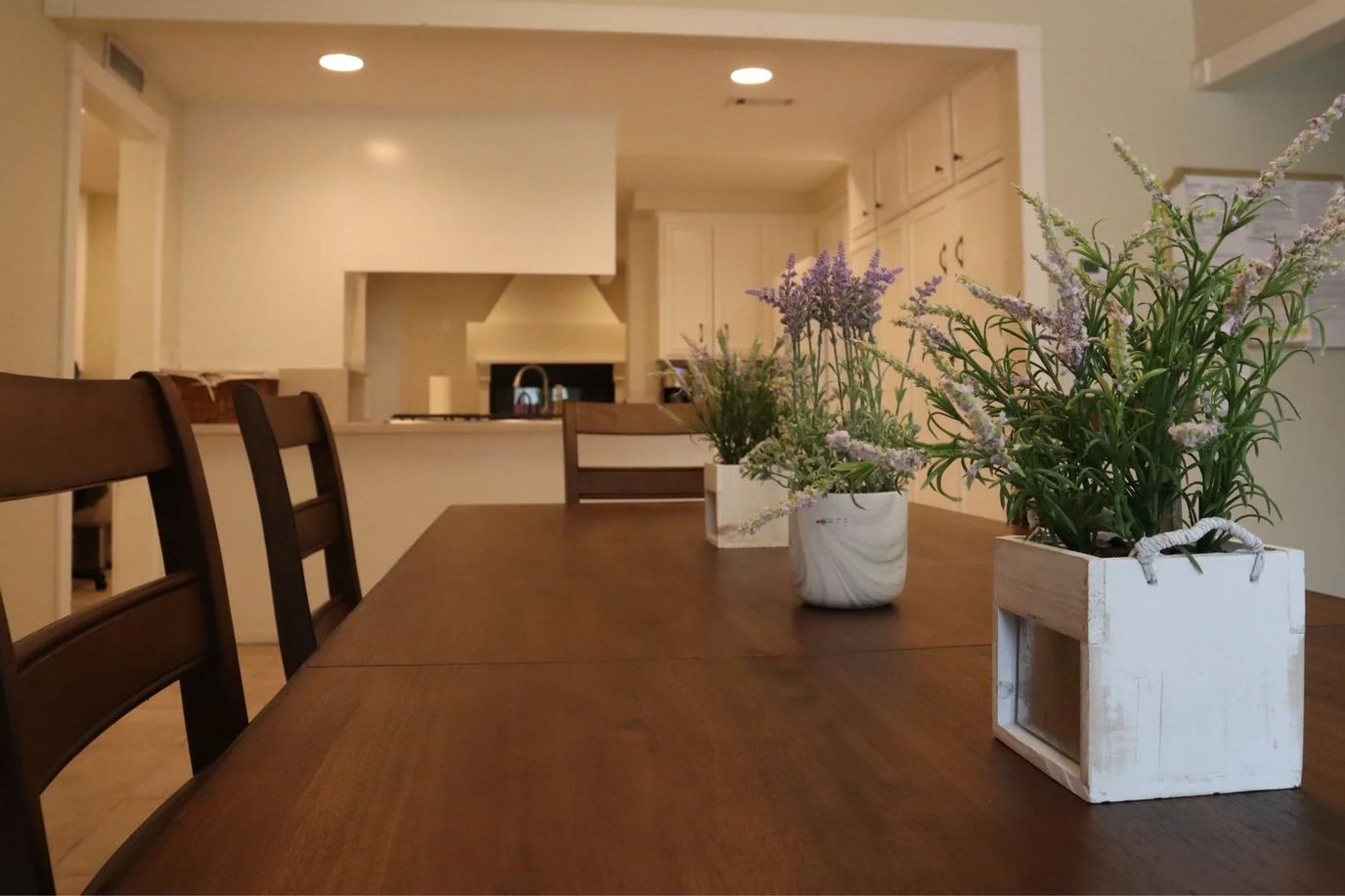 Dining area with wooden table and floral centerpieces