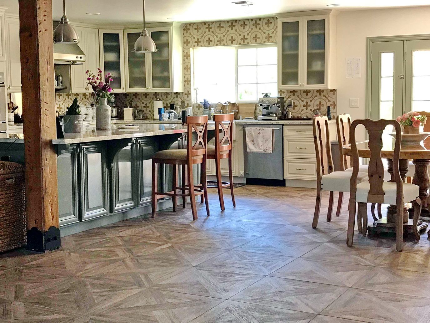 Bright kitchen area with wooden flooring and seating