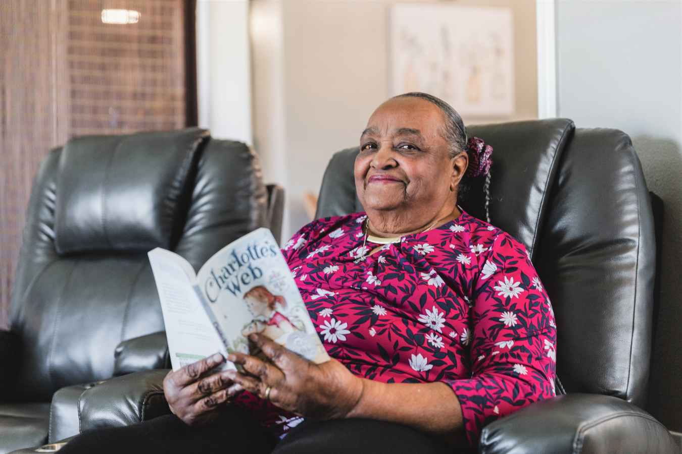 Resident reading a book in a common area