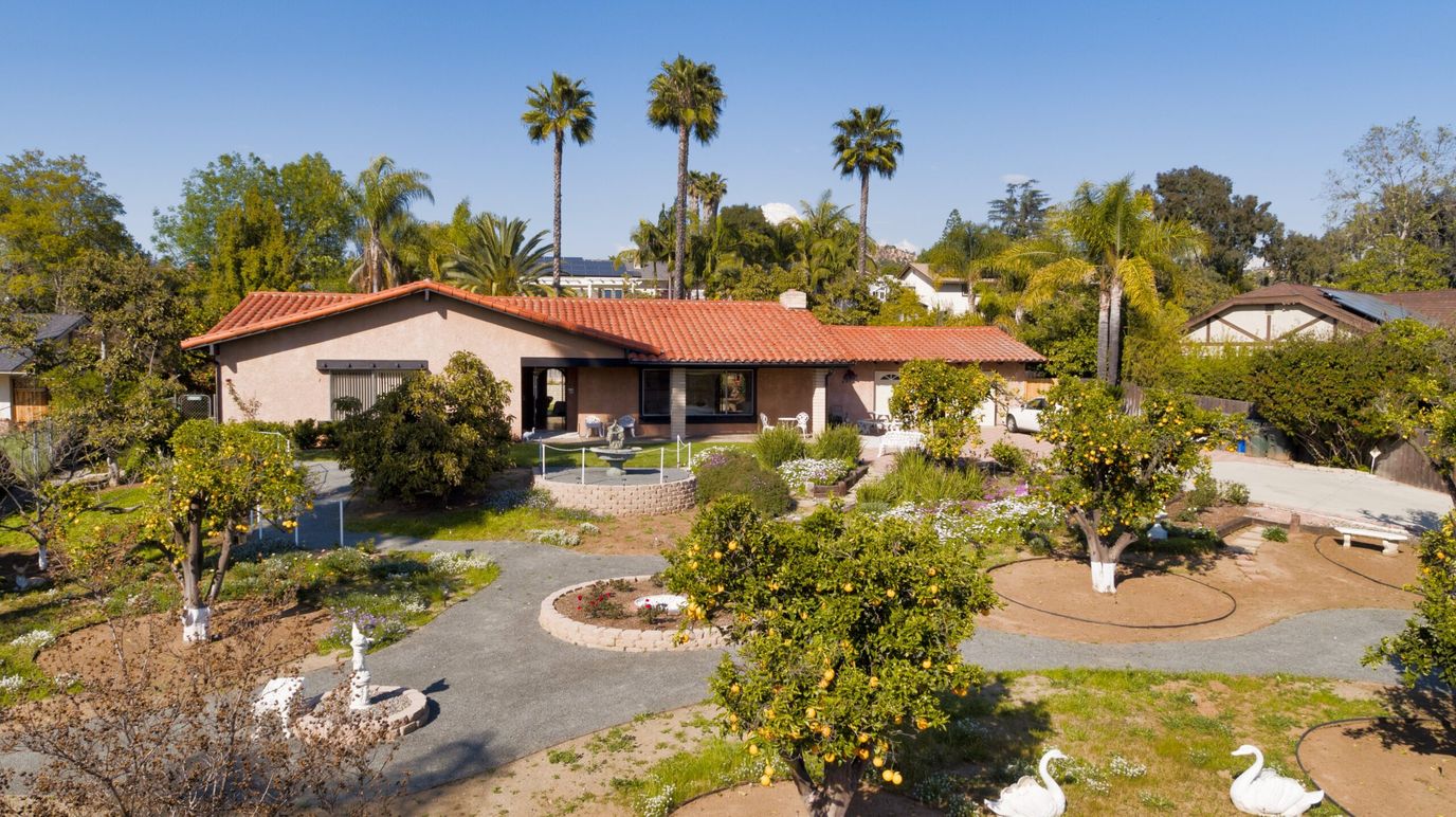 Aerial view of a senior living facility with gardens