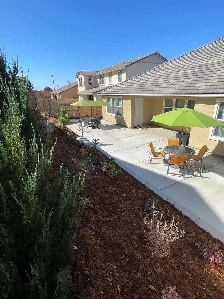 Outdoor seating area with umbrellas at the senior care facility