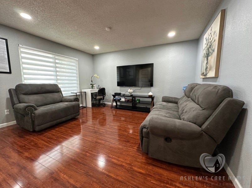 A common area with comfortable seating and a TV